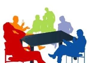 colored silouettes of people meeting around a table