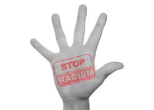 A hand with Stop Racism stamped on it in red ink