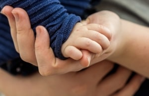 Close up of babys hand in mother's hand