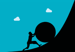 Silloutte of a man pushing a giant ball up hill