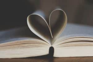 open book with pages folded like a heart