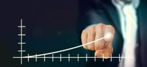 a graph line curving upwards and a finger pointing at the increase