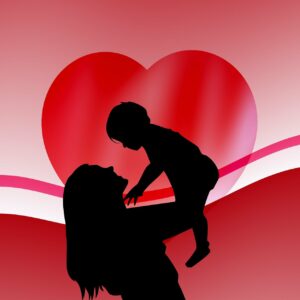 Silloute of mother holding a baby in the air. There is a big red heart in the background