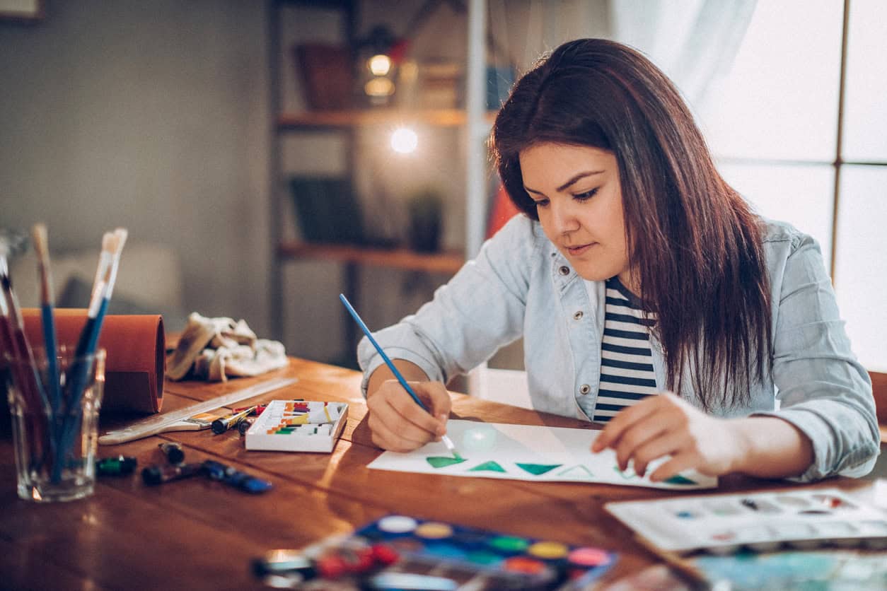 Young person painting at a table