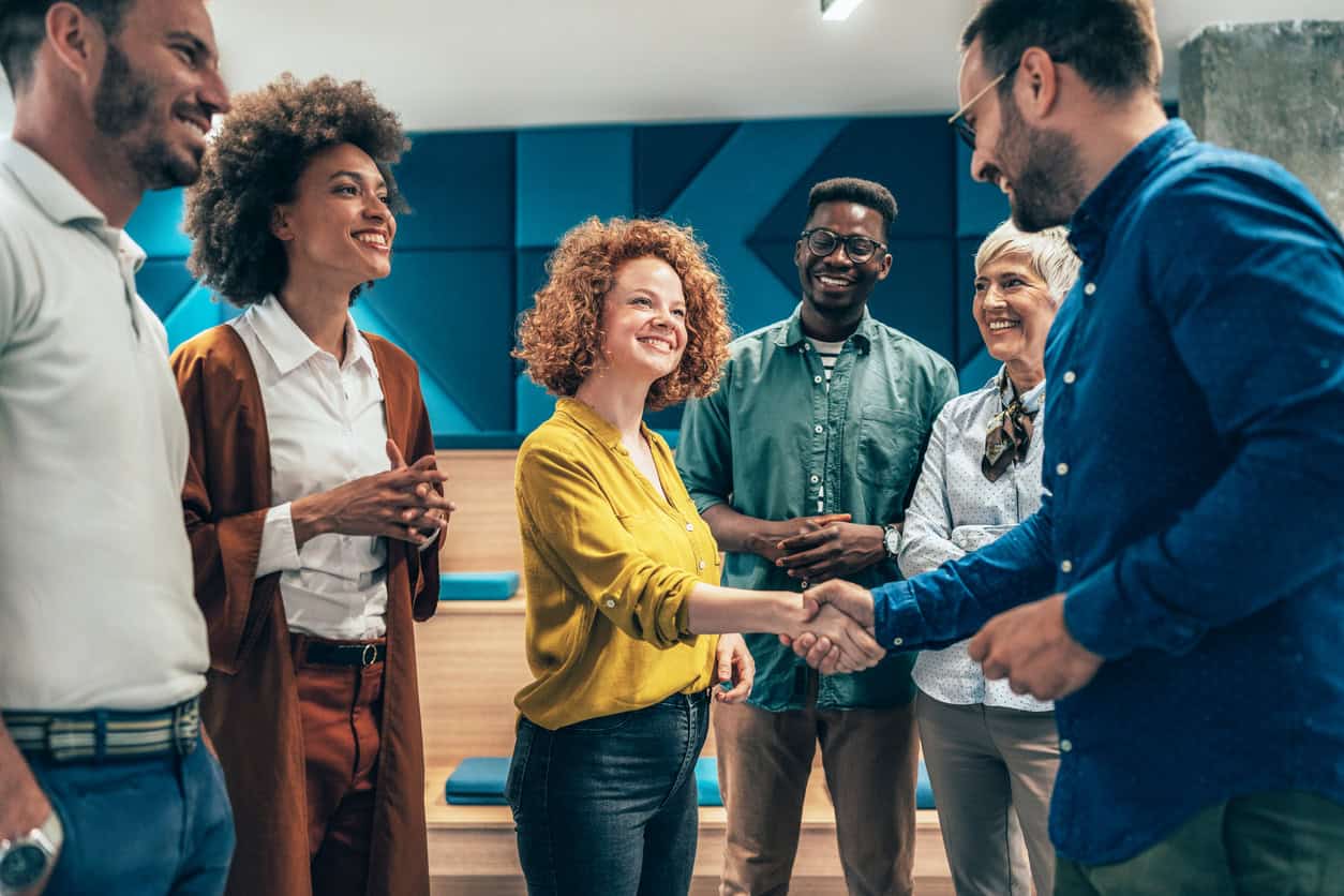 Happy businesswoman shaking hands with her colleague on a meeting in the office.