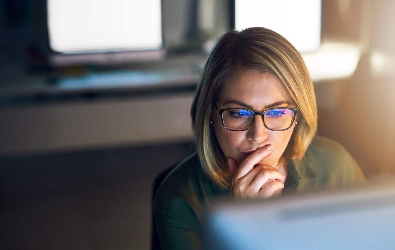 Shot of a young businesswoman working late on a computer in an office