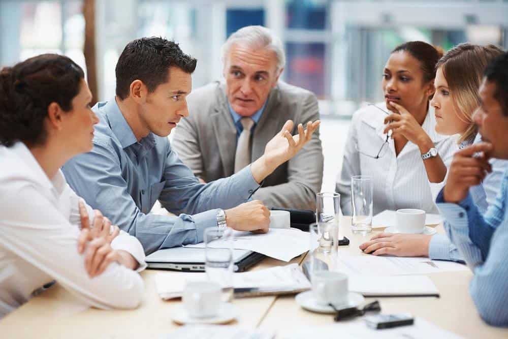 Three professionals sitting at a desk